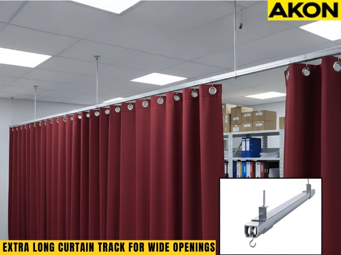 Extra long ceiling curtain track system installed over a wide industrial workspace