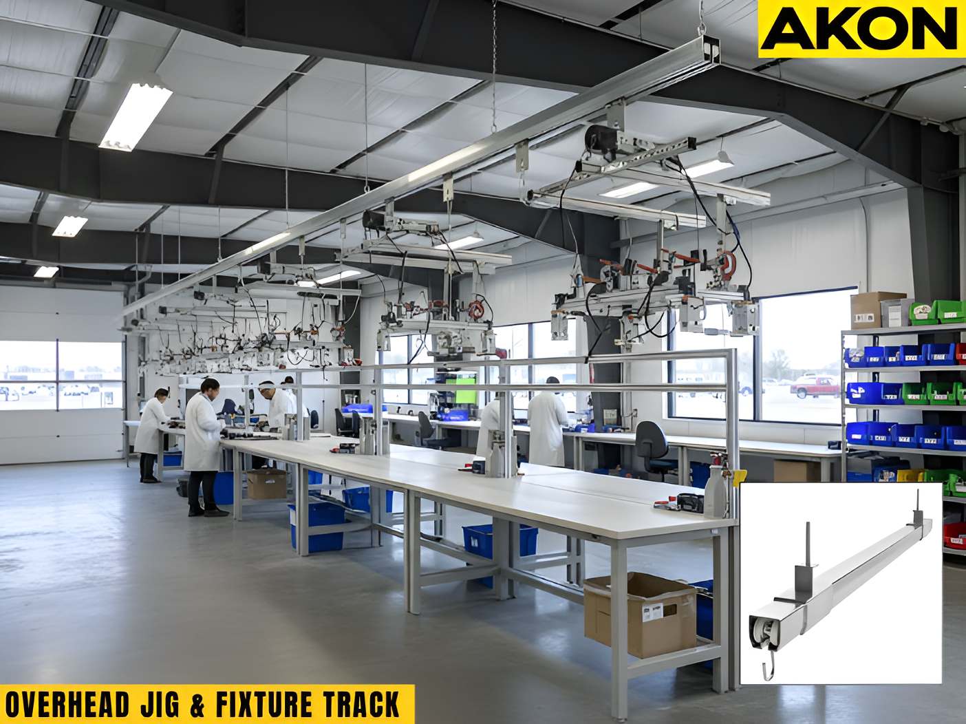 Overhead jig and fixture track system installed above assembly workstations with suspended positioning equipment