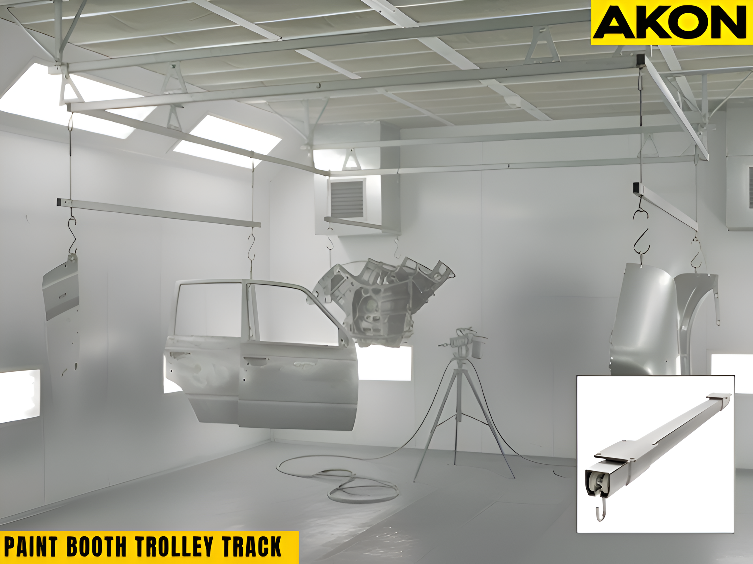 Overhead paint booth trolley track with suspended automotive panels for controlled spray workflow