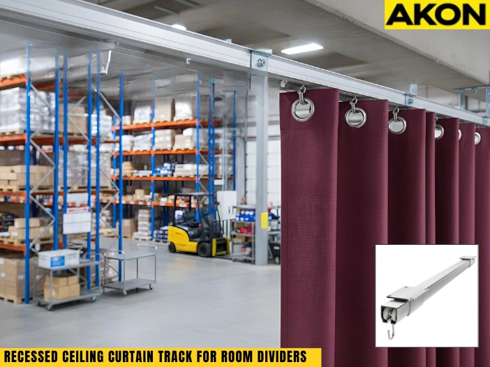 Recessed ceiling curtain track mounted in a workshop ceiling with heavy-duty divider curtains creating a clean work zone
