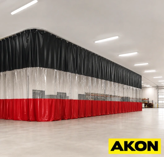 Heavy duty enclosed overhead curtain track mounted to a ceiling for industrial curtain applications.