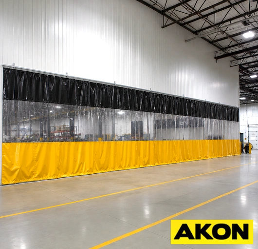 Ball bearing rollers mounted on a curtain track system in a warehouse setting.