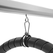 Overhead trolley on a steel track holding a coiled black hose