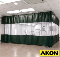 Paint booth enclosure with clear vinyl curtains and green lower panels on overhead track