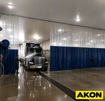 Truck wash bay with blue and clear vinyl curtains on overhead track